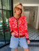 Woman wearing red bandana cardigan. Viral bandana cardigan. Wear to rodeos or just for western look.