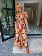 IT FALLS INTO PLACE SMOCKED MIDI DRESS