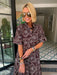 A woman wearing a brown and blue bandana patterned maxi shirt dress with short sleeves. Wear to a rodeo or western event. Gameday, Rodeo, Longhorn Football, Western