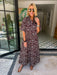 A woman wearing a brown and blue bandana patterned maxi shirt dress with short sleeves. Wear to a rodeo or western event. Gameday, Rodeo, Longhorn Football, Western