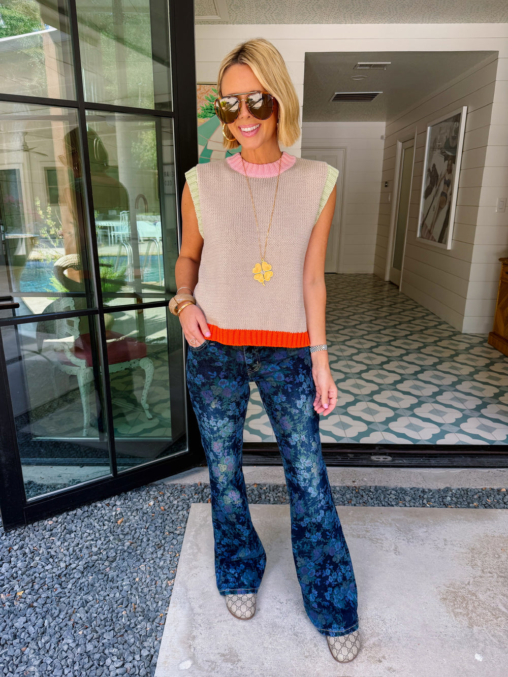 Woman wearing blue floral flare jeans with a subtle tonal pattern. Wear summer, fall or winter. Perfect for errand, casual mom look or casual friday. Dressy jeans.
