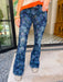 Woman wearing blue floral flare jeans with a subtle tonal pattern. Wear summer, fall or winter. Perfect for errand, casual mom look or casual friday. Dressy jeans.

