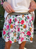 Woman wearing sporty, edgy floral skort. Perfect for moms running errands or carpooling. Pair with matching top or any tee.
