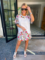Woman wearing sporty, edgy floral skort. Has built in shorts with pockets! Perfect for moms running errands or carpooling. Pair with matching top or any tee.
