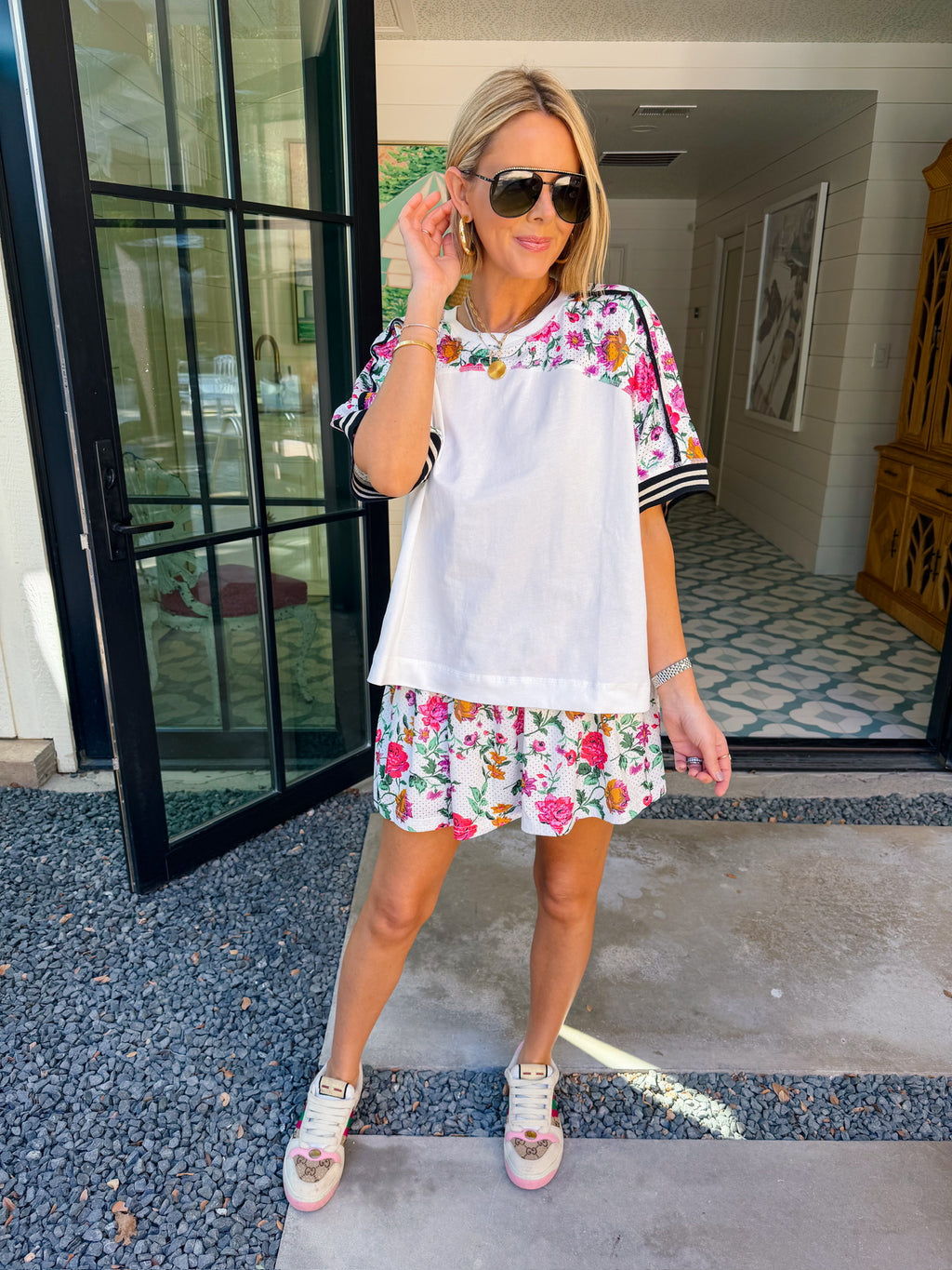 Woman wearing sporty, edgy floral skort. Has built in shorts with pockets! Perfect for moms running errands or carpooling. Pair with matching top or any tee.