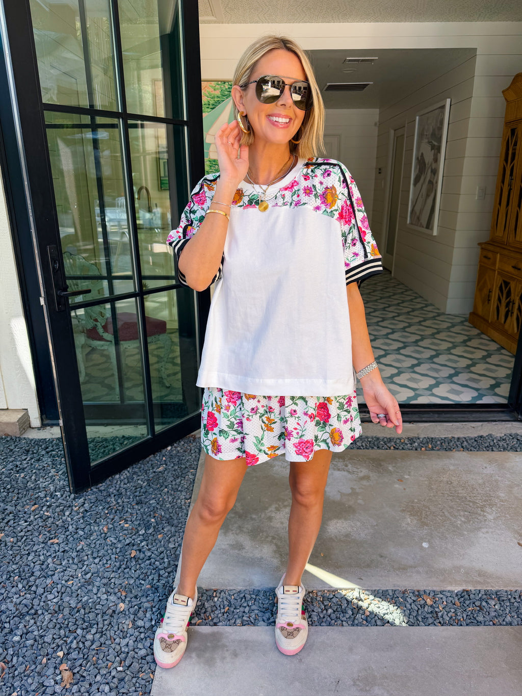 Woman wearing sporty, edgy floral skort. Has built in shorts with pockets! Perfect for moms running errands or carpooling. Pair with matching top or any tee.