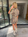A woman wears an edgy tiger print romper. Gameday look for LSU Tigers. Concert outfit. Trendy tiger print.