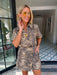 A woman wears an edgy tiger print romper. Gameday look for LSU Tigers. Concert outfit. Trendy tiger print.