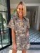 A woman wears an edgy tiger print romper. Gameday look for LSU Tigers. Concert outfit. Trendy tiger print.