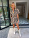 A woman wears an edgy tiger print romper. Gameday look for LSU Tigers. Concert outfit. Trendy tiger print.