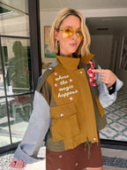 A woman models a color-block utility jacket with denim and green colorblocking. The jacket is fun, edgy and brings all the magic to everyday activities. Wear this jacket to round top, a rodeo, or running around town. The best  lightweight, casual fall layer. A must have for busy chic moms on the go.