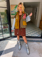 A woman models a color-block utility jacket with denim and green colorblocking. Wear this jacket to round top, a rodeo, or running around town. The best  lightweight, casual fall layer. A must have for busy chic moms on the go.